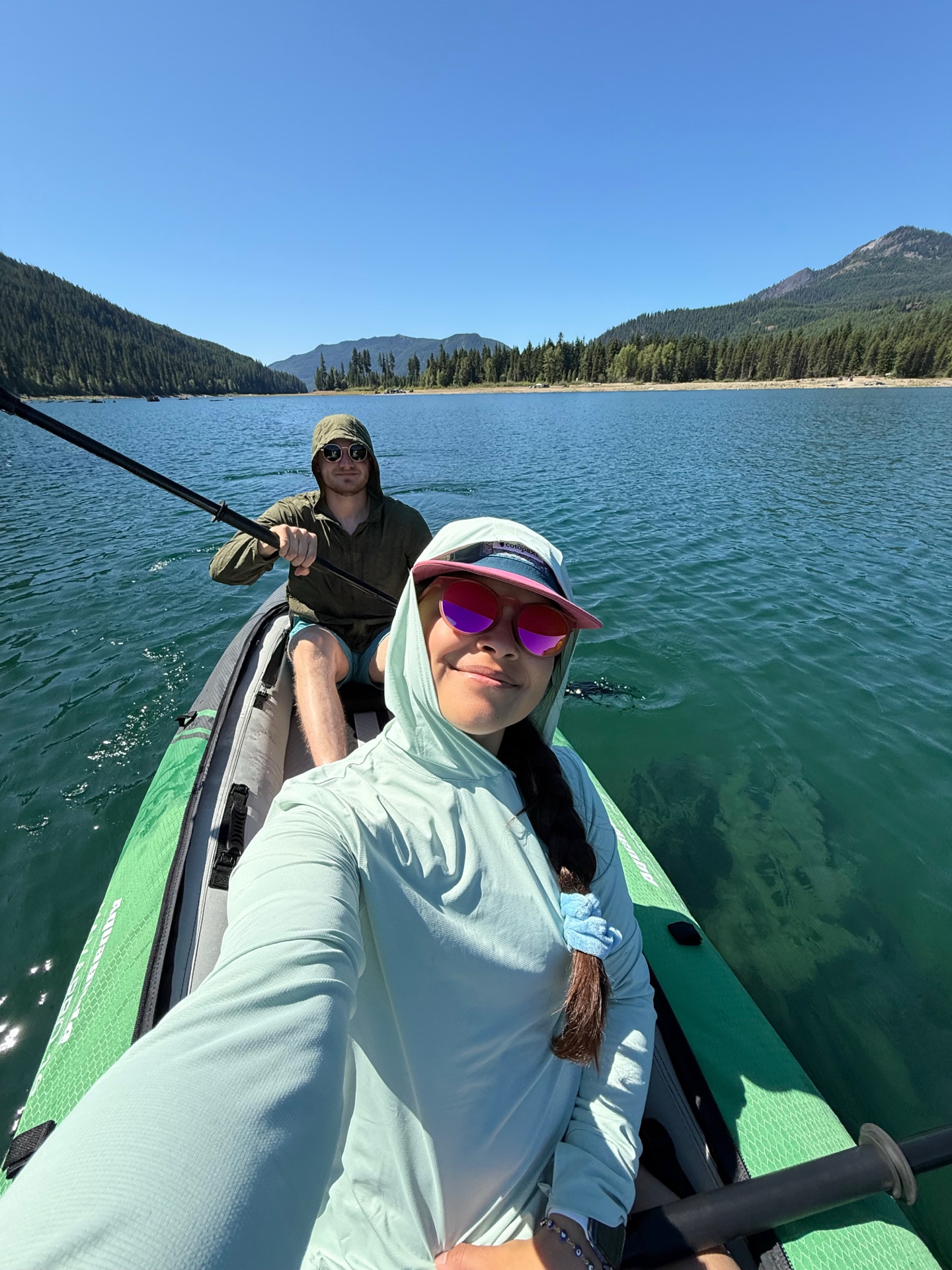 Sophia and Lucas kayaking on a mountain lake